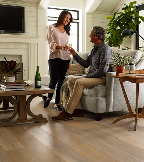 people in living room with hardwood flooring from Carpet Innovations in Denver, CO