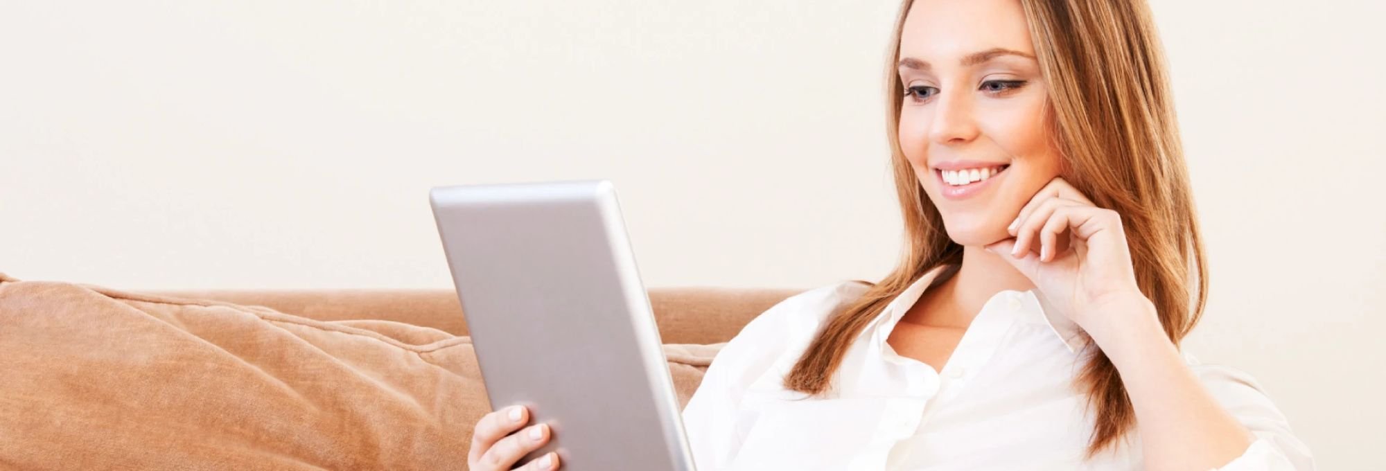 Woman browsing the Internet on a tablet - Carpet Innovations in Denver, CO