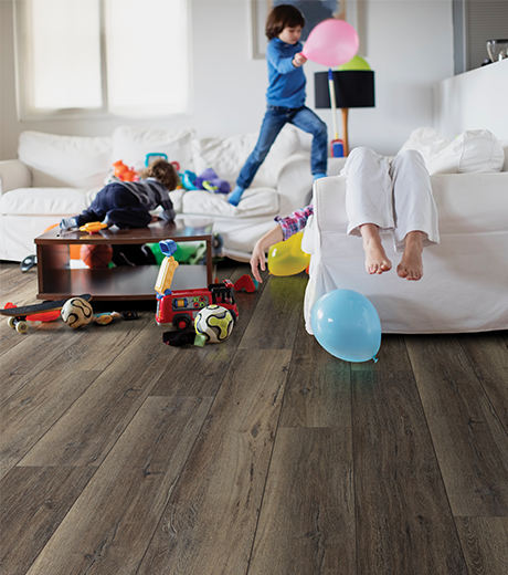 kids playing in room with wood-look laminate flooring from Carpet Innovations in Denver, CO