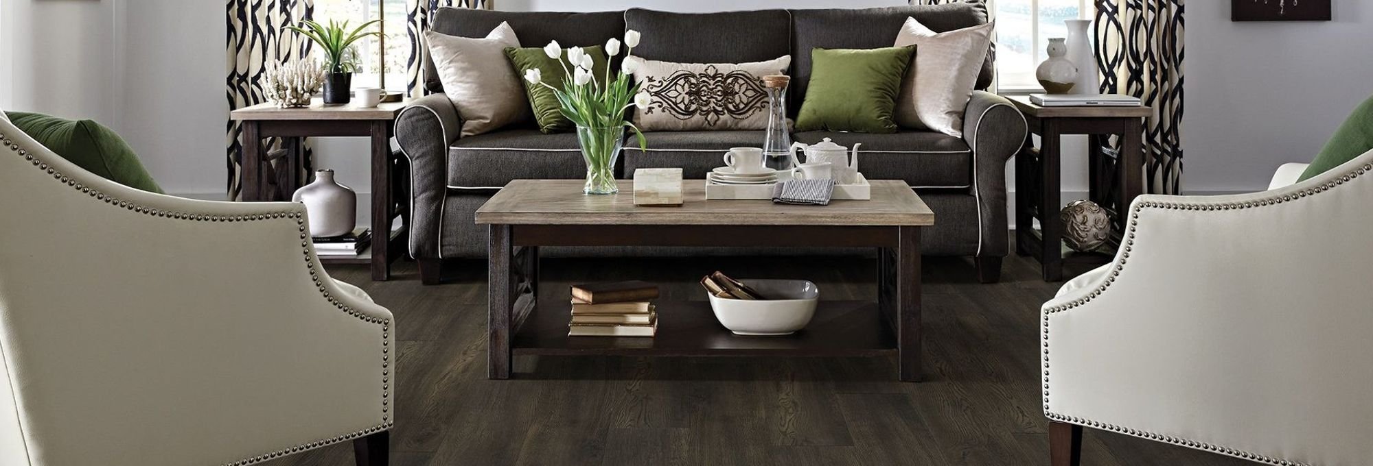 Living room with dark wood-look laminate flooring from Carpet Innovations in Denver, CO
